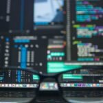 Eyeglasses reflecting computer code on a monitor, ideal for technology and programming themes.