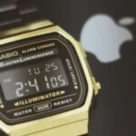 Close-up of a black Casio watch resting on a black smartphone, India