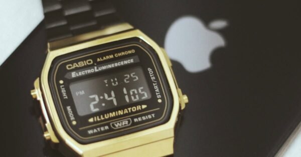 Close-up of a black Casio watch resting on a black smartphone, India